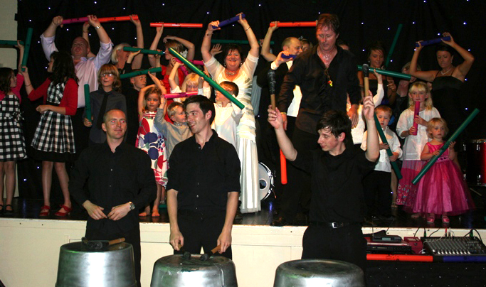 Drummers onstage with a wedding party playing boomwhackers - weddings and private events