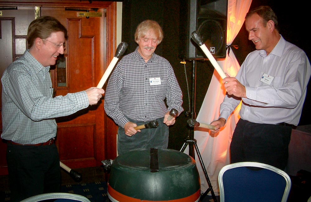 Delegates playing barrel drums - team building drum energisers in Europe